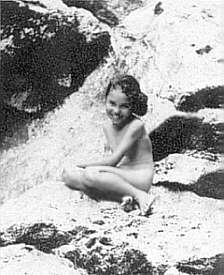 Maori girl by a waterfall