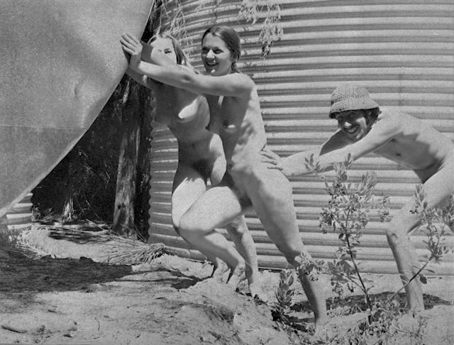Two girls pushing a tank